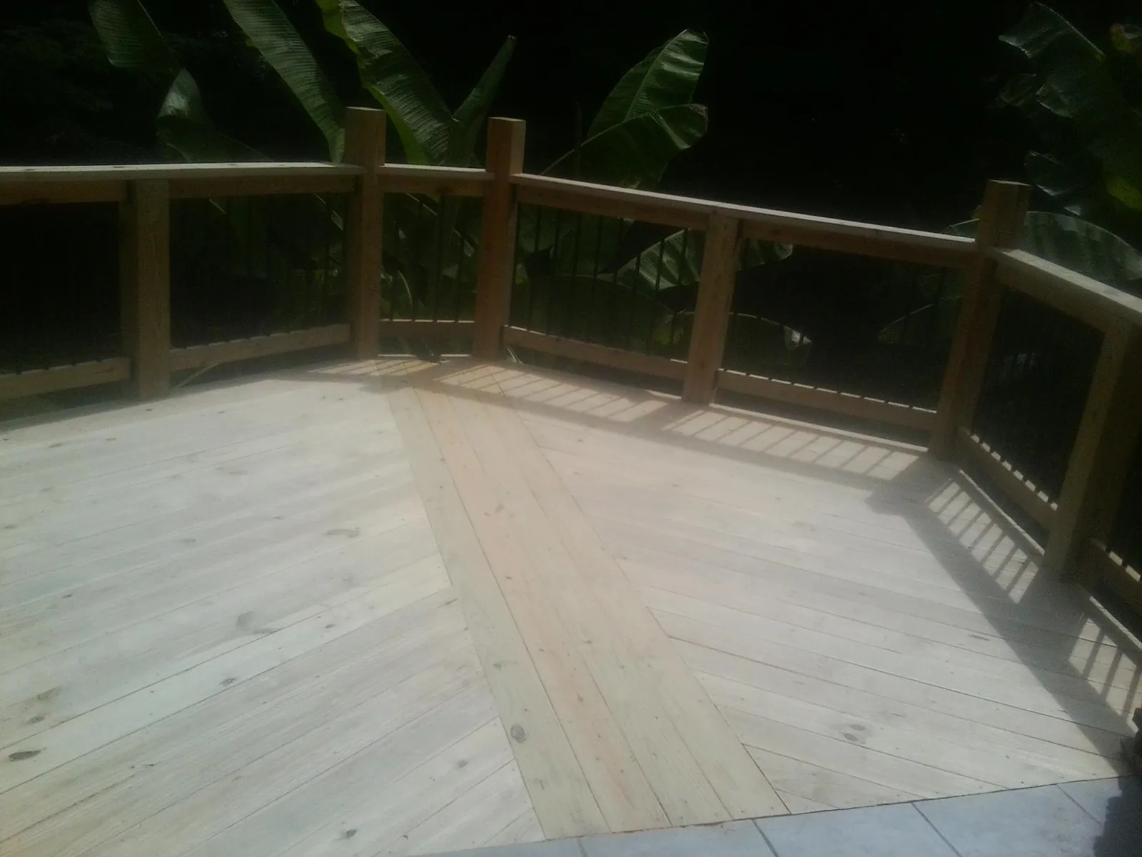 New wood deck and railing built off the back of a home in Wyoming