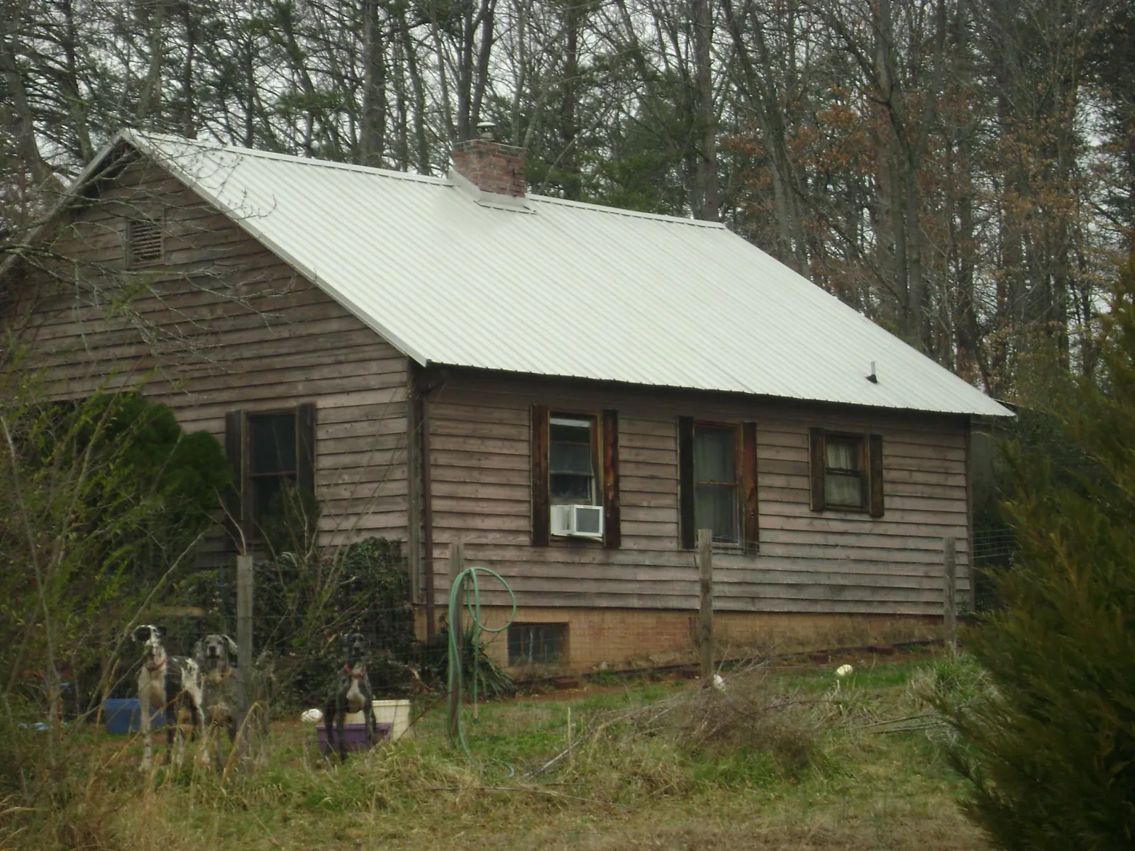 White metal roof on an old wood sided farmhouse, from a Metal Roof Installation job in Wyoming